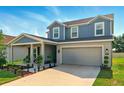 Beautiful two-story home featuring a covered front porch and an attached two-car garage at 700 Trotters Dr, Eagle Lake, FL 33839