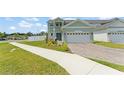 Beautiful two-story home featuring a paved driveway, well-maintained landscaping, and an attached garage at 701 Dennis Ave, Orlando, FL 32807
