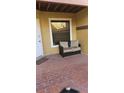Brick patio with an outdoor couch, window, and white door, perfect for relaxing at 706 Lighthouse Ct, Altamonte Springs, FL 32714