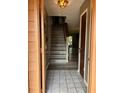 Entryway showing wood-look flooring, stairway to upper level, and open view to living area at 707 Carpenters Way # 50, Lakeland, FL 33809