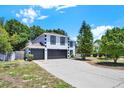 Two-story home boasts a three-car garage, crisp white paint, and contrasted black trim at 809 Deer Glen Ct, Fruitland Park, FL 34731