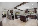 Spacious kitchen featuring dark wood cabinets, a center island, and modern stainless-steel appliances at 8655 Shady Glen Dr, Orlando, FL 32819