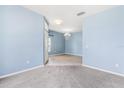 Spacious entryway showcasing tile and carpet flooring with an elegant chandelier lighting the open space at 9644 Myrtle Creek Ln, Orlando, FL 32832
