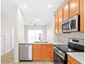 Well-equipped kitchen features stainless steel appliances, granite countertops, and convenient access to the dining area at 10914 Savannah Wood Dr # 139, Orlando, FL 32832