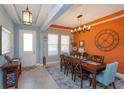 Bright dining room with modern lighting, a large clock, and a spacious dining table with seating for six at 14830 Winkfield Ct, Winter Garden, FL 34787