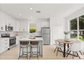 Well-lit kitchen boasts stainless steel appliances and a breakfast bar at 14927 Faversham Cir, Orlando, FL 32826