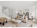 Bright open-plan living area features light wood floors and modern decor at 14927 Faversham Cir, Orlando, FL 32826