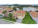 An aerial view shows a beautiful home close to a lake and other houses in a lovely neighborhood at 1640 Oak Blossom Dr, Davenport, FL 33837