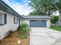 Attached two-car garage with a concrete driveway and a meticulously maintained landscape bed at 228 Kilmer Ln, Winter Haven, FL 33884