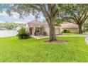Well-maintained single-story home with lush green lawn and mature shade trees at 2280 Yorville Ct, Ocoee, FL 34761