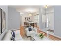 Bright living room features wood floors, dining area, and ample natural light at 2280 Yorville Ct, Ocoee, FL 34761