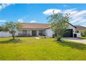 Beautifully landscaped front yard with mature trees and a well-maintained lawn, creating an inviting curb appeal at 2406 Placid Way, Kissimmee, FL 34758