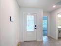 Bright entryway with a modern front door, tile flooring, and recessed lighting at 2836 Sanctuary Dr, Clermont, FL 34714