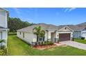 Well-maintained single-story home with neat landscaping and a paved driveway at 2836 Sanctuary Dr, Clermont, FL 34714