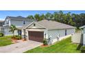 Single-story home featuring a paver driveway and meticulously maintained landscaping at 2836 Sanctuary Dr, Clermont, FL 34714