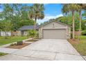 Charming single-story home with stone accents, manicured lawn, and two-car garage on a sunny day at 2901 Autumnwood Trl, Apopka, FL 32703