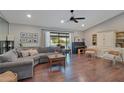 Spacious living room with hardwood floors, and a large sectional sofa perfect for relaxing and entertaining at 2901 Autumnwood Trl, Apopka, FL 32703