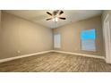 Bright bedroom with wood-look tile flooring and two windows for ample natural light at 344 Buenaventura Blvd, Kissimmee, FL 34743
