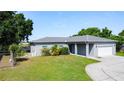 Single story home featuring a well-manicured lawn and two car garage at 344 Buenaventura Blvd, Kissimmee, FL 34743