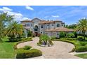 Stately luxury home boasts professional landscaping, circular driveway, and a tile roof at 4071 Isabella Cir, Windermere, FL 34786