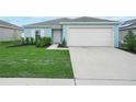 Single-story home has attached garage, appealing curb appeal, a landscaped yard and concrete driveway at 440 Patricia Alford Dr, Haines City, FL 33844