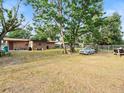 Large grassy backyard with mature trees, offering plenty of room for outdoor entertainment at 4546 Malibu St, Orlando, FL 32811