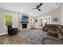Living room boasts a stone fireplace, vaulted ceiling, and sliding glass doors at 5 W Village Dr, Oviedo, FL 32765