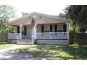 Charming single-story home featuring a covered front porch, a welcoming entrance, and neatly landscaped surroundings at 5054 Mcdonald Rd, Zellwood, FL 32798