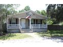 Single story home featuring a covered front porch, a welcoming entrance and nice landscaping at 5054 Mcdonald Rd, Zellwood, FL 32798