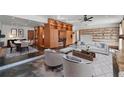 Spacious living room with modern decor, wooden cabinetry, and seating, seamlessly connecting the spaces at 6327 Ridgeberry Dr, Orlando, FL 32819