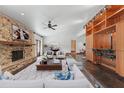 Open-concept living room features a stone fireplace, modern furnishings, and access to the bar area at 6327 Ridgeberry Dr, Orlando, FL 32819