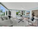 Bright sunroom with large windows offering views of the landscaped backyard at 8134 Hook Cir, Orlando, FL 32836