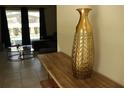 Stylish living room showcasing a modern vase, and a glimpse of a serene outdoor space at 8930 Zurich Ln, Kissimmee, FL 34747