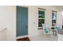 Inviting front porch featuring a rocking chair and charming decor at 9425 Holliston Creek Pl, Winter Garden, FL 34787