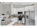 Modern kitchen featuring stainless steel appliances and granite countertops at 9616 River Walk Ct, Orlando, FL 32825