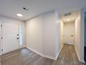 Neutral entryway showcasing light wood-look floors and a front door with sidelight window at 965 Brentwood Dr, Apopka, FL 32712