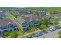 A planned community shown from above features green spaces, sidewalks, and plentiful parking at 10520 Burrows St, Orlando, FL 32832