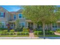 Charming townhome with a well-manicured lawn and mature tree at 10520 Burrows St, Orlando, FL 32832