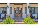 Elegant double front door flanked by stone columns, accentuating the home's curb appeal at 10845 Bayshore Dr, Windermere, FL 34786