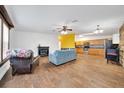 Open-concept living room and kitchen featuring hardwood floors and stainless steel appliances, perfect for entertaining at 1115 S Mary St, Eustis, FL 32726