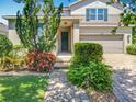 Well-manicured landscaping frames the walkway leading to the home's inviting front door at 11868 Thatcher Ave, Orlando, FL 32836