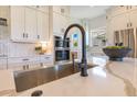 Modern kitchen featuring granite countertops, stainless steel sink and appliances and custom backsplash at 13791 Abberwick Dr, Orlando, FL 32832