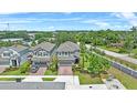 The aerial view shows a well-maintained home with a lush green lawn in a peaceful neighborhood at 1425 Paget Cv, Sanford, FL 32771