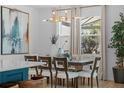 The dining area features a modern chandelier and a large window at 1425 Paget Cv, Sanford, FL 32771