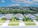 Aerial view showcasing the home's position within a quiet neighborhood, adjacent to green space at 14325 Hidden Ct, Clermont, FL 34711