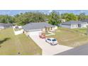 Beautiful ranch-style house with an attached garage and a white car parked in the driveway at 15303 Sw 52Nd Cir, Ocala, FL 34473