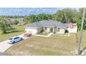 Beautiful ranch-style house with an attached garage and a red storage shed in the back at 15303 Sw 52Nd Cir, Ocala, FL 34473