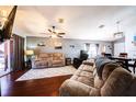 Spacious living room offering a relaxing atmosphere with plush sofas, hardwood floors, and plenty of natural light at 156 Carrera Ave, Davenport, FL 33897