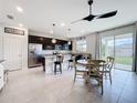 Open kitchen with stainless steel appliances, dark cabinets, and an adjacent dining area at 15865 Bradicks Ct, Clermont, FL 34711