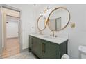 Stylish bathroom with a dual sink vanity, quartz countertop, and elegant gold-tone fixtures at 1623 Cumbie Ave, Orlando, FL 32804